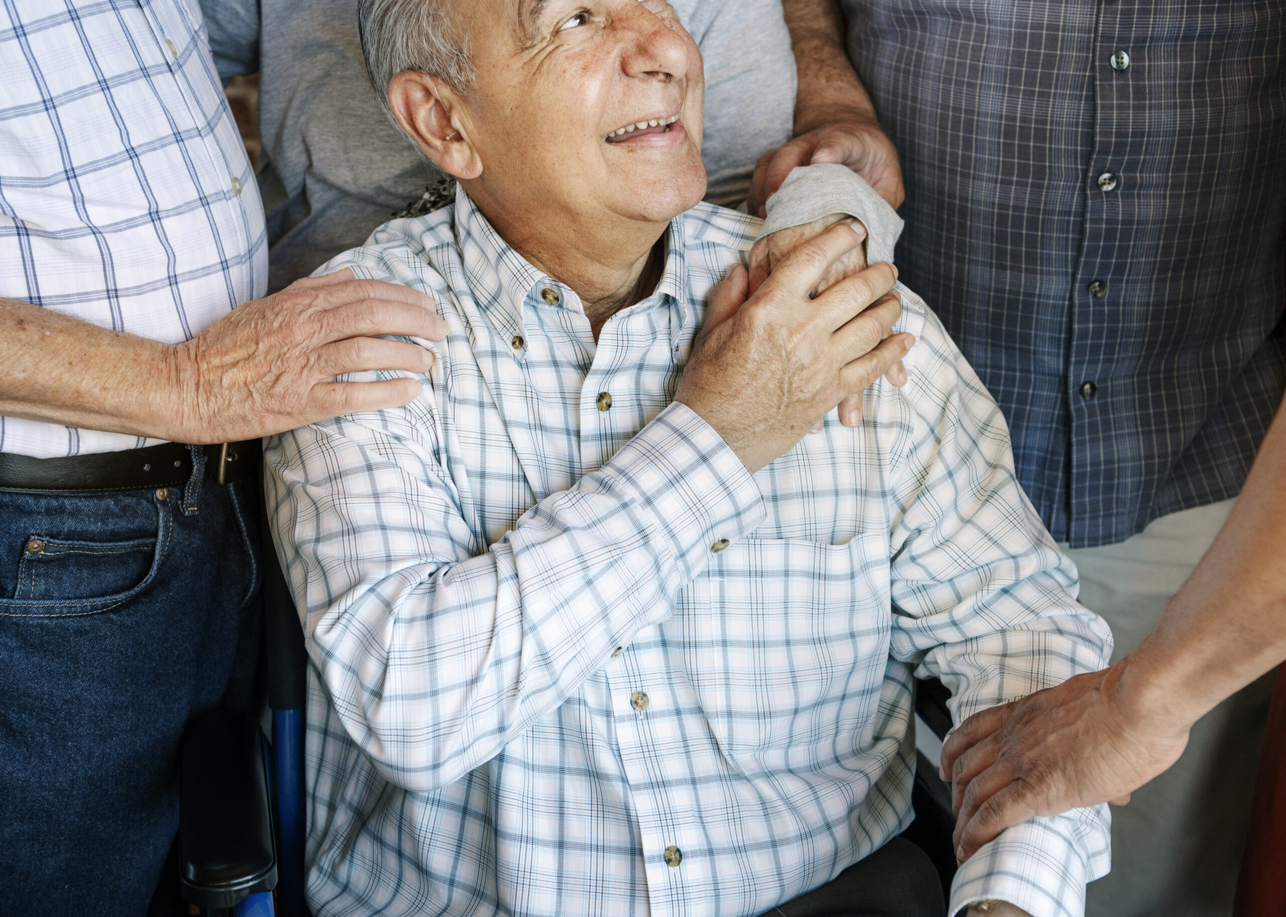 Elderly men cheer up his friend on a wheelchair