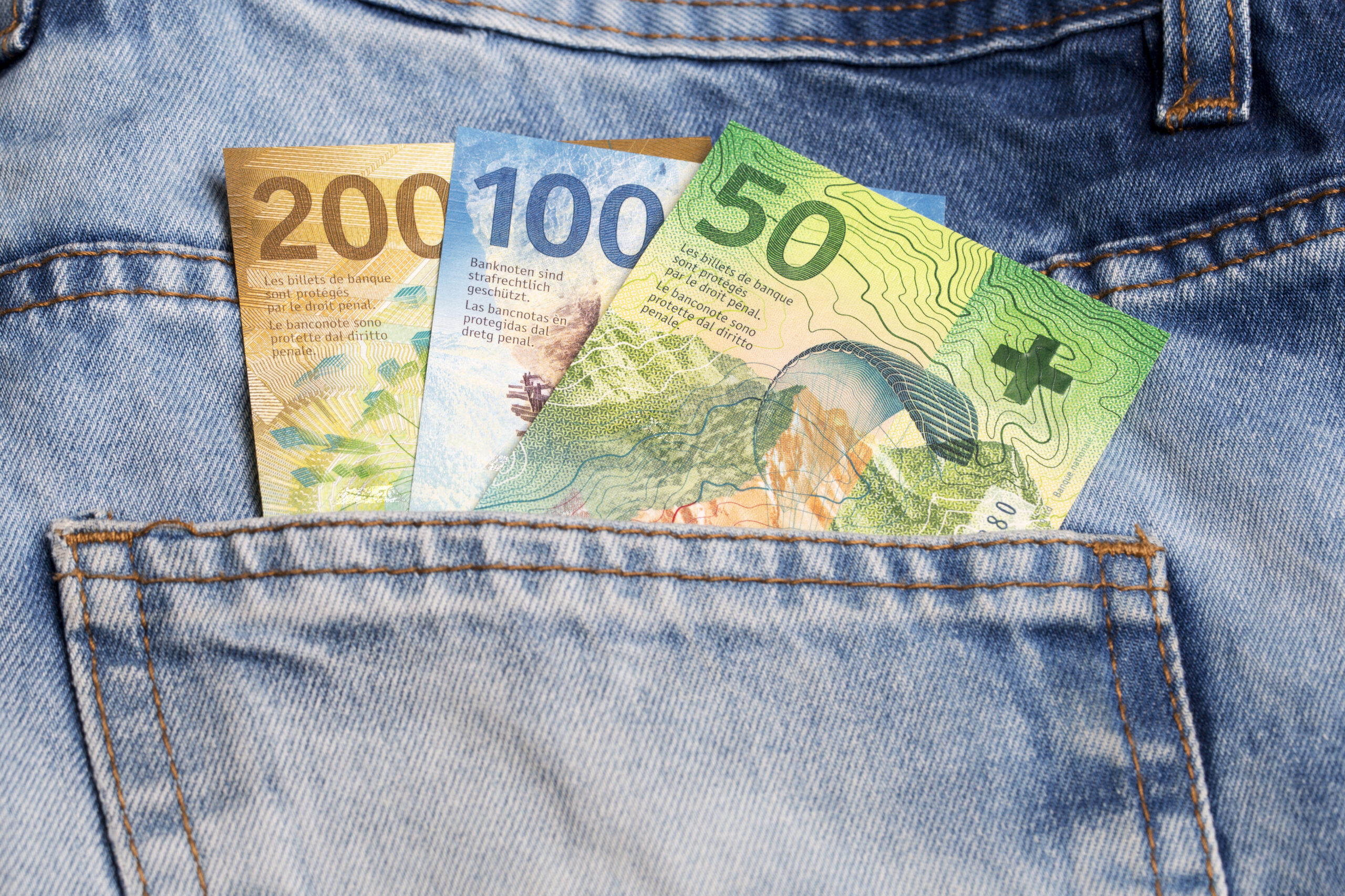 Swiss money - franc in the pocket of blue jeans